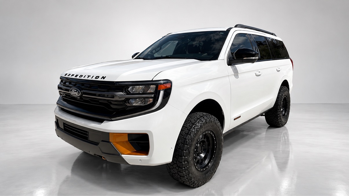 Gloss white Ford Expedition SUV shown from the front three-quarter angle on a light studio floor after a full exterior detail